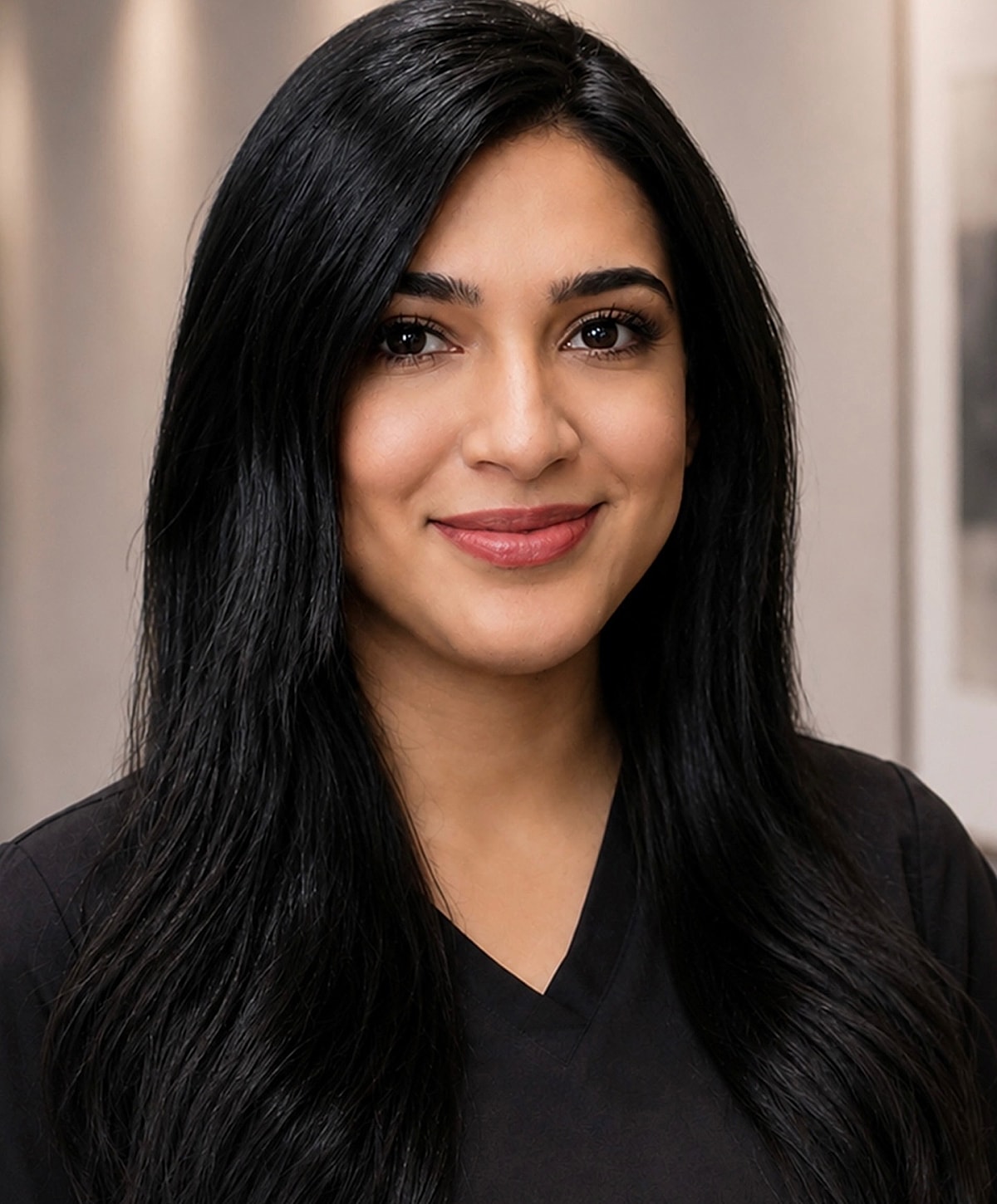 Smiling woman in professional attire, indoors.