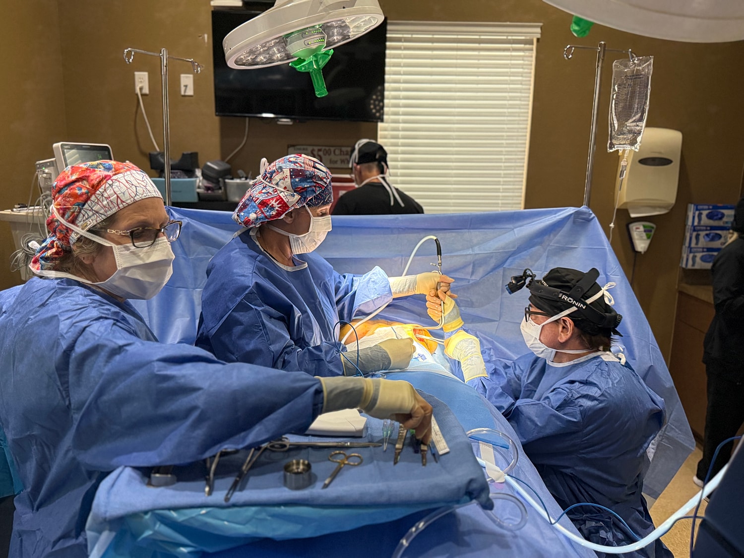 Surgical team performing procedure in operating room.